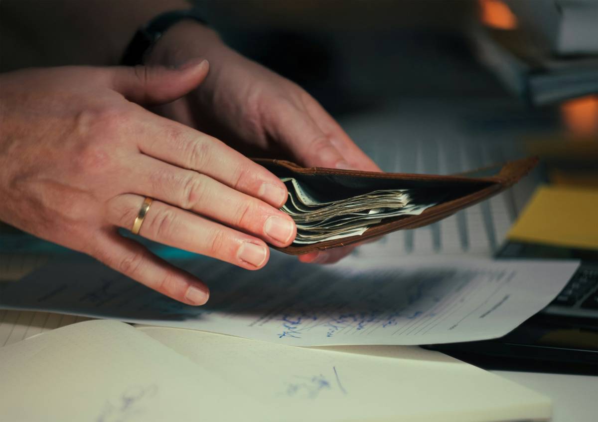 Couple reviewing Dual User Spending Limits on mobile banking app together at kitchen table