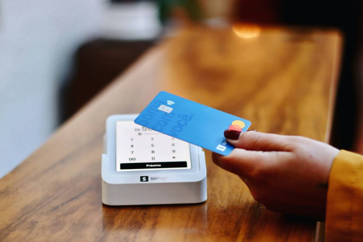 Couple reviewing joint credit card apply documents at kitchen table
