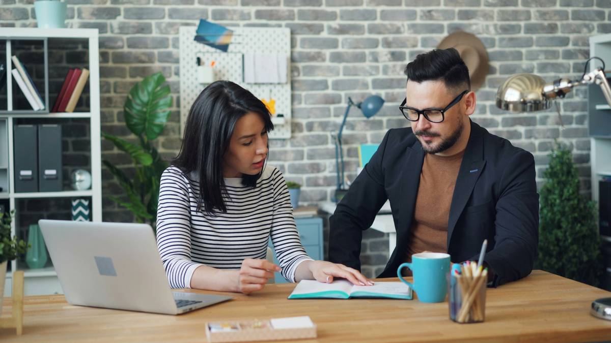Couple reviewing joint credit card application low fees terms on laptop