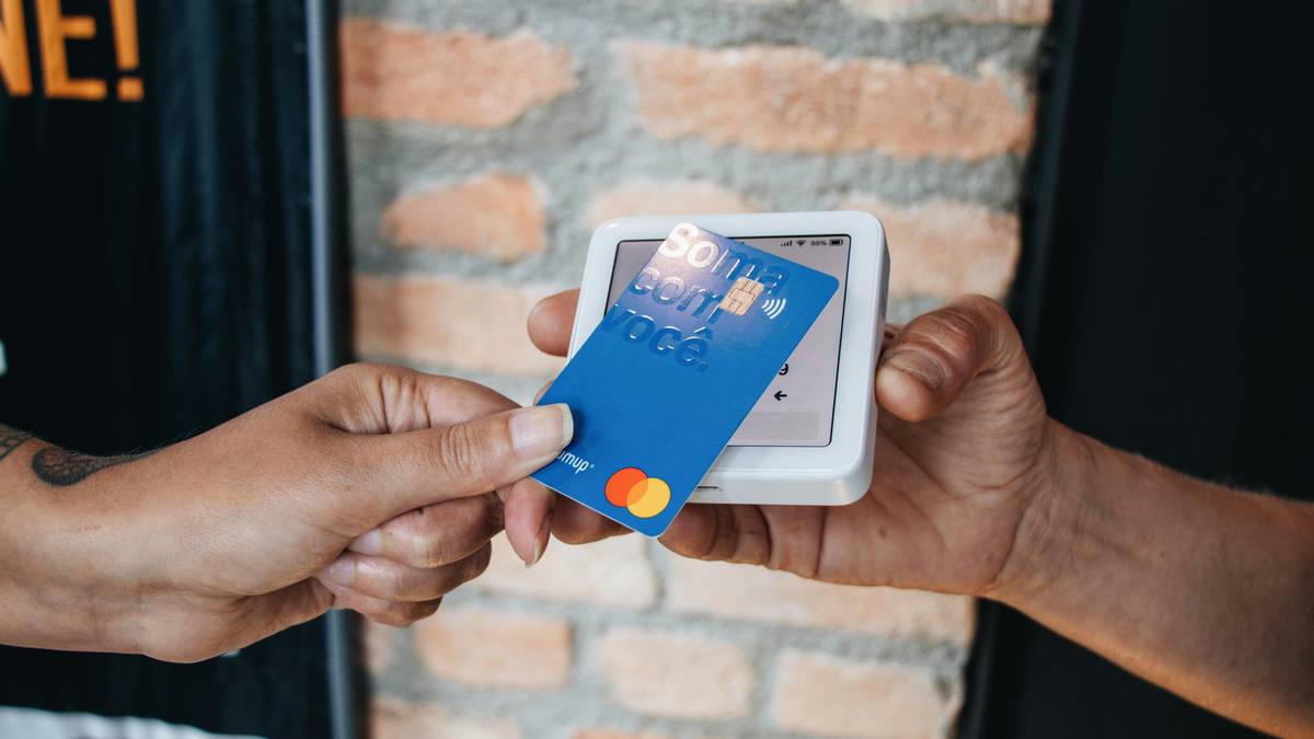 Couple reviewing joint credit card statement with application are loan better than credit highlighted on screen